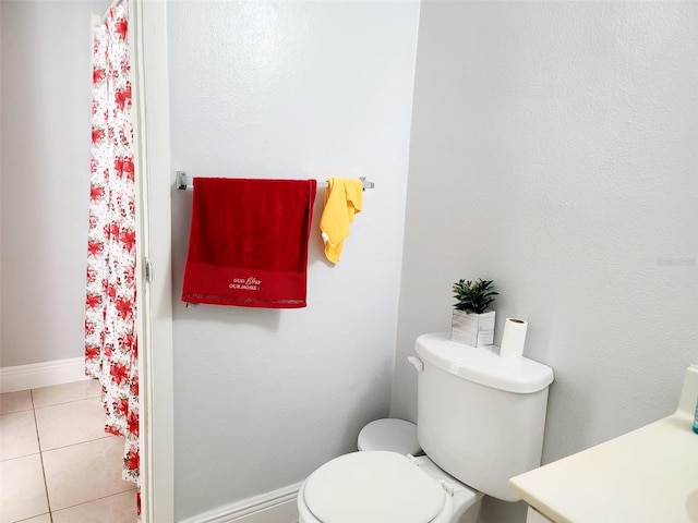 bathroom featuring tile patterned floors, vanity, and toilet