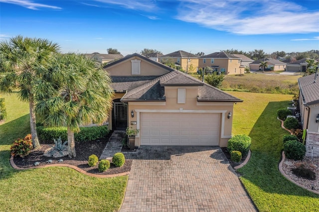 view of front of house featuring a front lawn and a garage