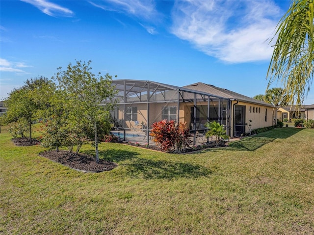 rear view of property with a yard and glass enclosure