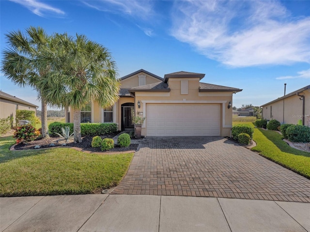 view of front of house with a garage and a front lawn