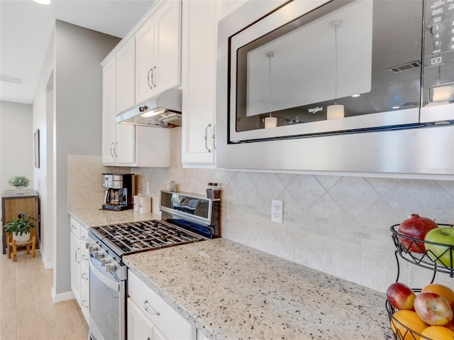 kitchen featuring white cabinetry, appliances with stainless steel finishes, light stone counters, and decorative backsplash