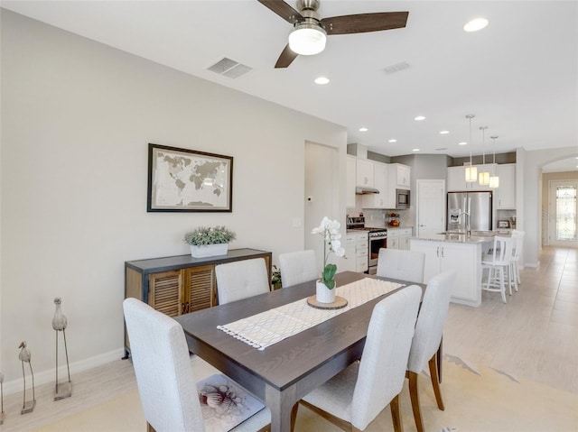 dining space with ceiling fan and sink