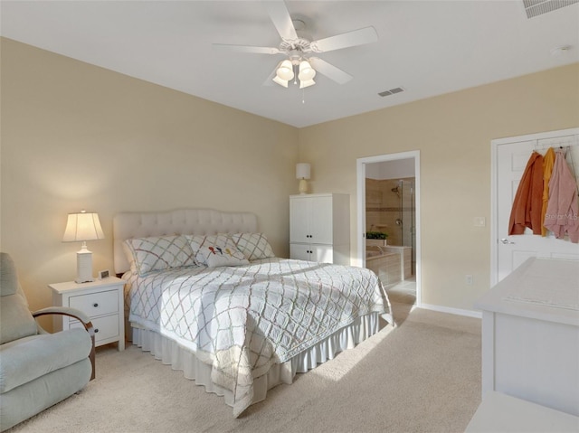 carpeted bedroom featuring ceiling fan and ensuite bathroom