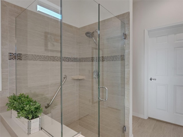 bathroom featuring a shower with shower door