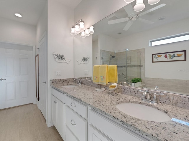 bathroom featuring vanity, an enclosed shower, and ceiling fan