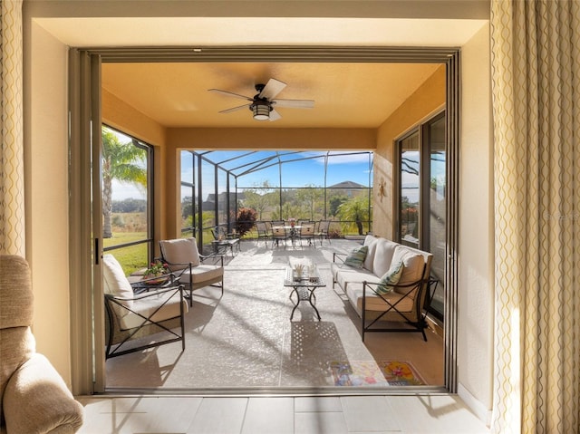 sunroom / solarium featuring ceiling fan