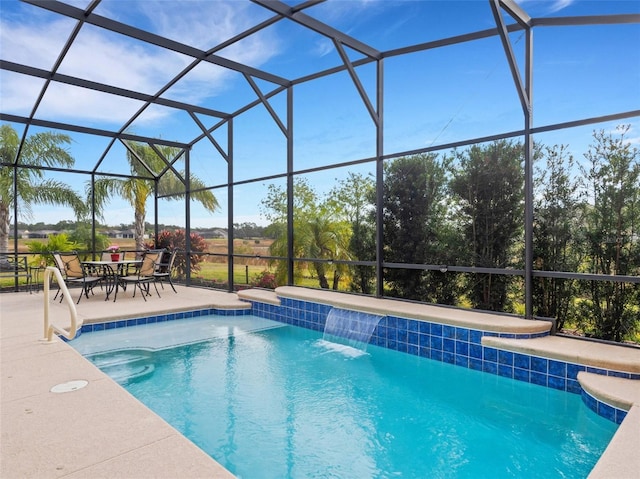 view of pool with a patio, pool water feature, and glass enclosure