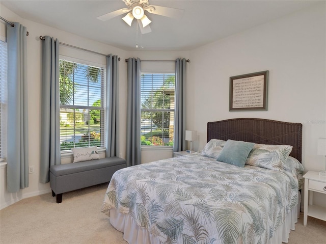 bedroom featuring light colored carpet and ceiling fan