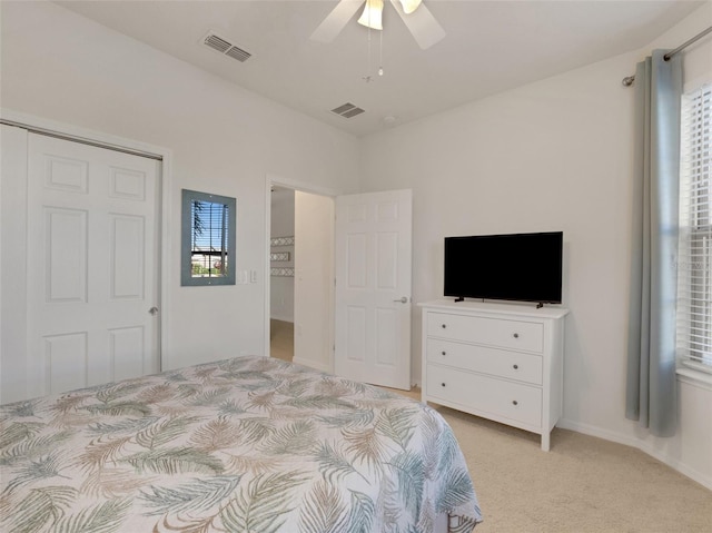 carpeted bedroom featuring ceiling fan and a closet