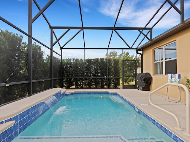 view of swimming pool with area for grilling, a patio, a lanai, and pool water feature