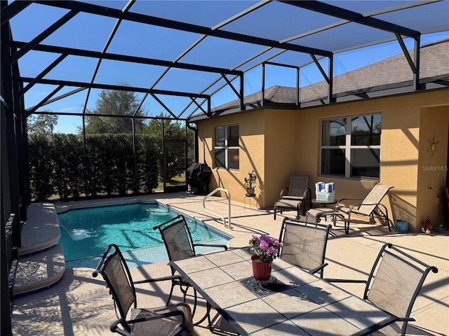 view of pool featuring a patio and glass enclosure