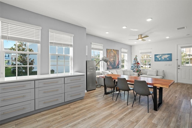 dining space featuring ceiling fan and light hardwood / wood-style flooring