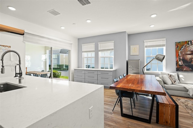 kitchen featuring gray cabinetry, sink, and light hardwood / wood-style floors