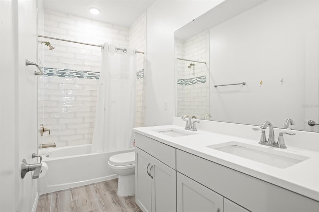 full bathroom featuring vanity, hardwood / wood-style floors, shower / bathtub combination with curtain, and toilet