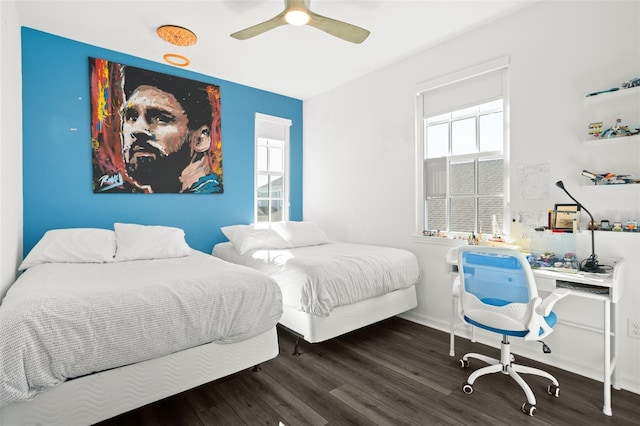 bedroom with dark hardwood / wood-style flooring and ceiling fan