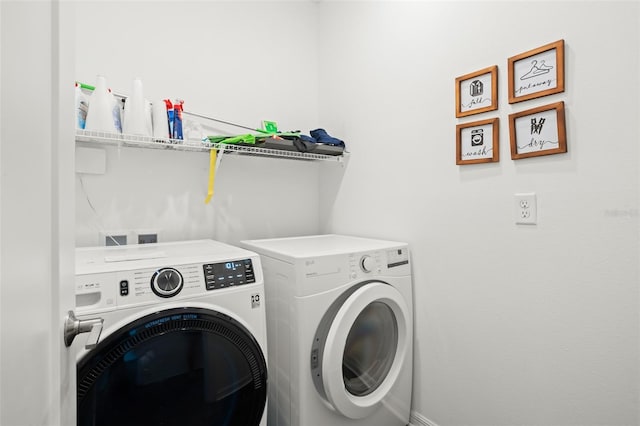 washroom featuring washer and clothes dryer