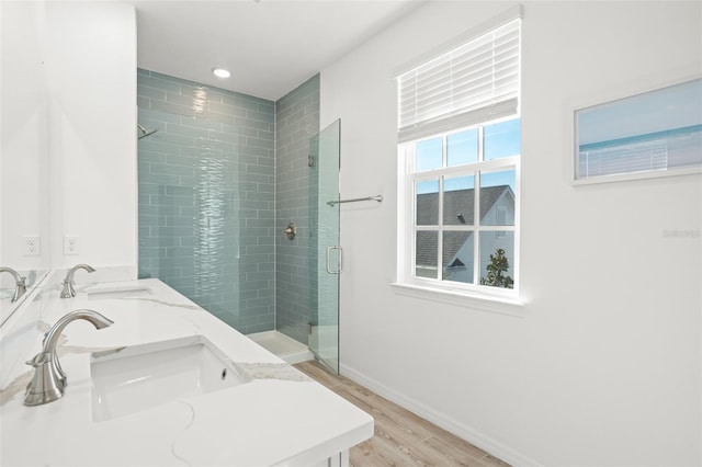 bathroom featuring hardwood / wood-style floors, vanity, and walk in shower