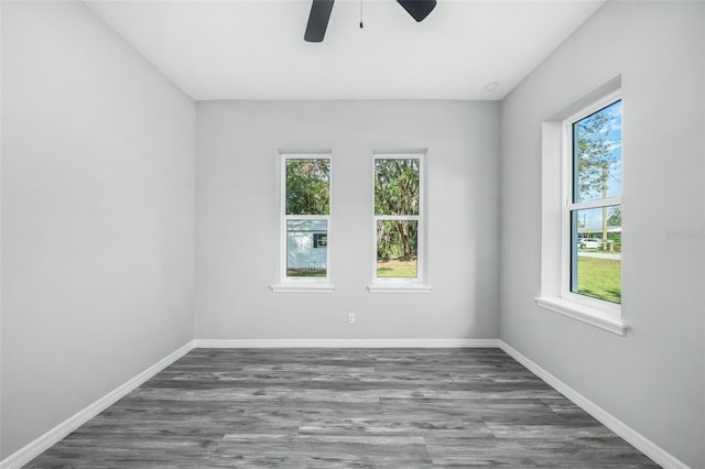 unfurnished room featuring ceiling fan and dark hardwood / wood-style flooring