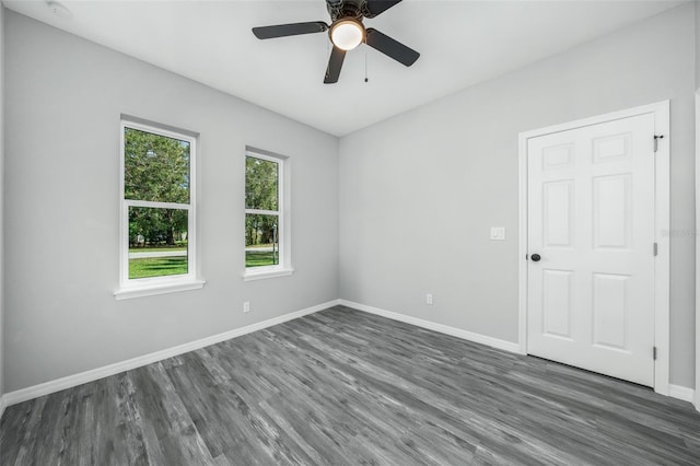 empty room with ceiling fan and dark wood-type flooring