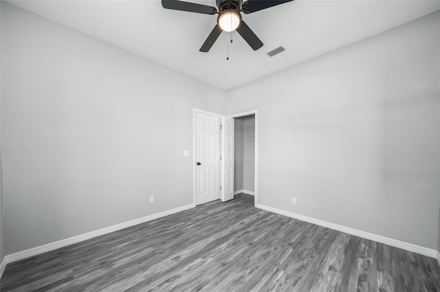 unfurnished room with ceiling fan and dark hardwood / wood-style floors