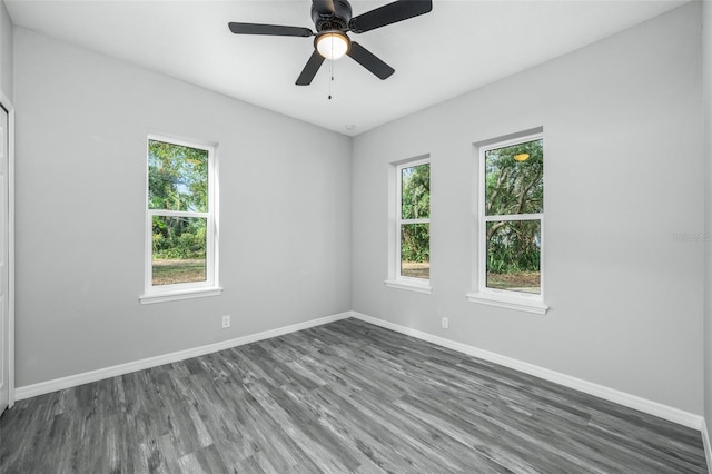 empty room featuring ceiling fan and dark hardwood / wood-style flooring