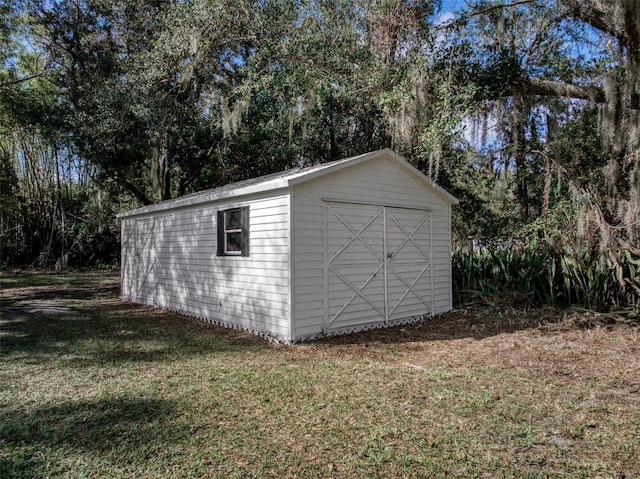 view of outbuilding featuring a lawn