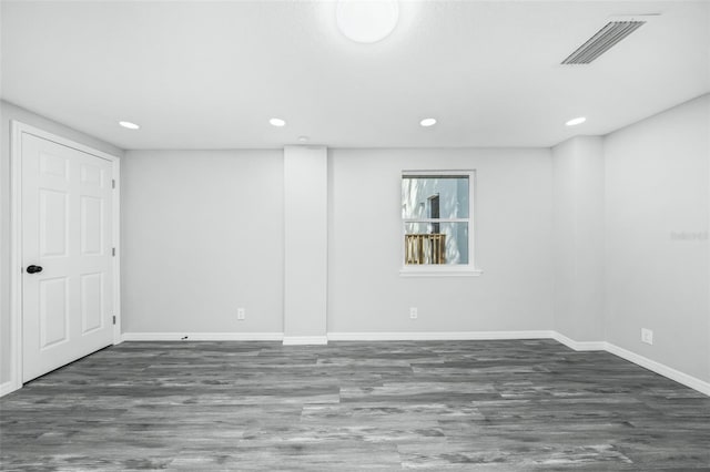 basement with dark hardwood / wood-style floors