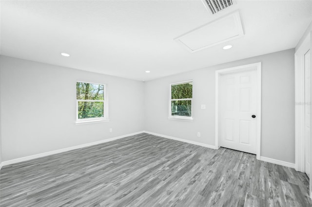 spare room with a wealth of natural light and light hardwood / wood-style flooring