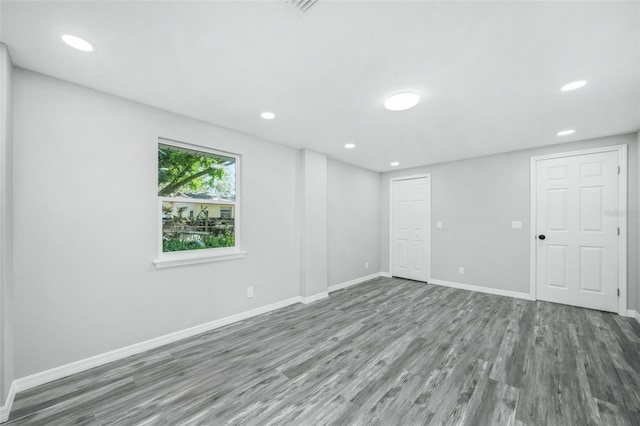 unfurnished room featuring hardwood / wood-style flooring