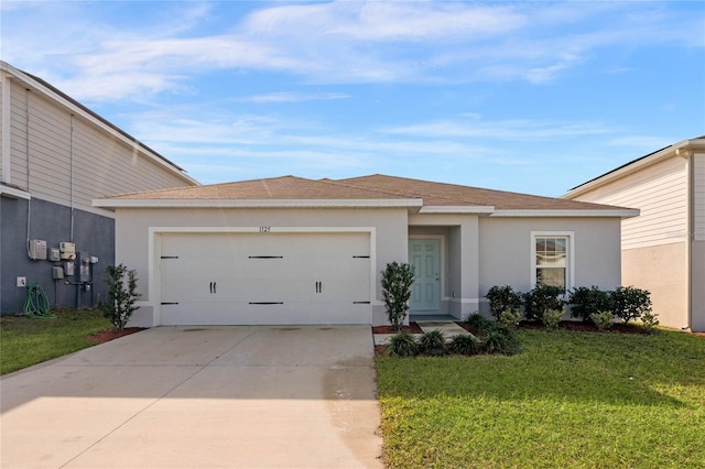 view of front of home featuring a garage and a front yard