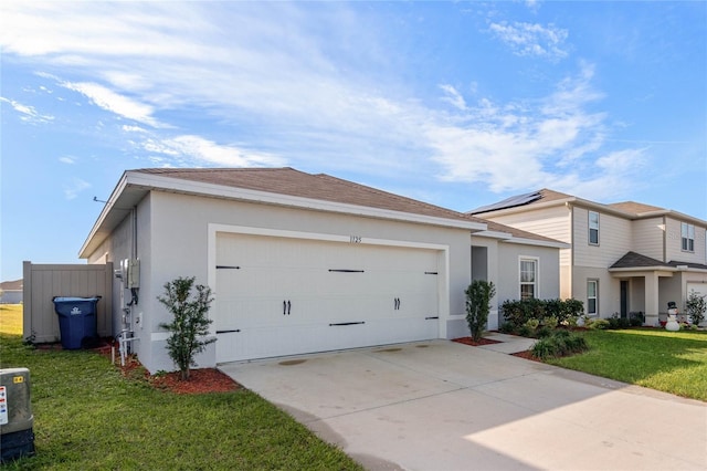 view of front of home with a garage and a front yard