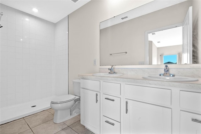 bathroom featuring tile patterned floors, vanity, toilet, and walk in shower