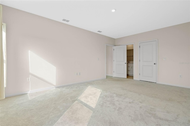 unfurnished bedroom with light carpet