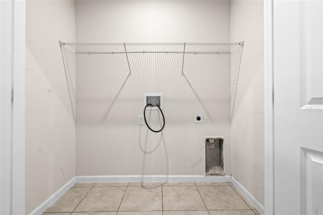 laundry room featuring hookup for a washing machine, light tile patterned floors, and electric dryer hookup