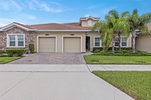 view of front of home featuring a garage and a front lawn