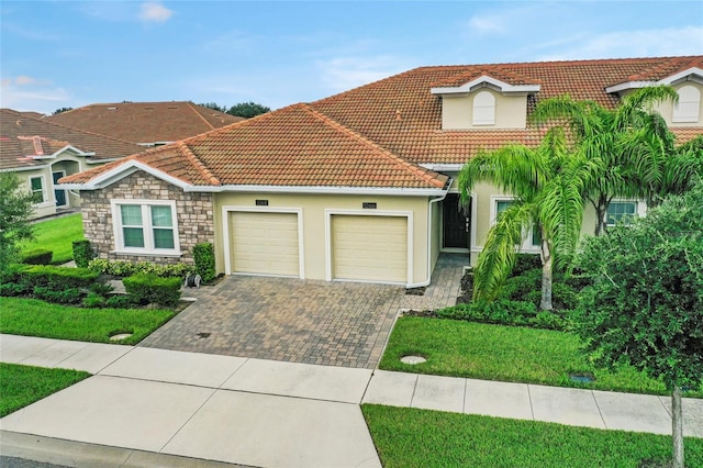 view of front of home with a garage and a front lawn