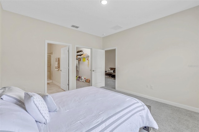 bedroom featuring light colored carpet and connected bathroom