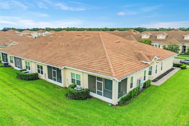 back of property with a yard and cooling unit