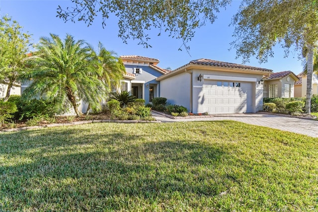 mediterranean / spanish home featuring a front lawn and a garage