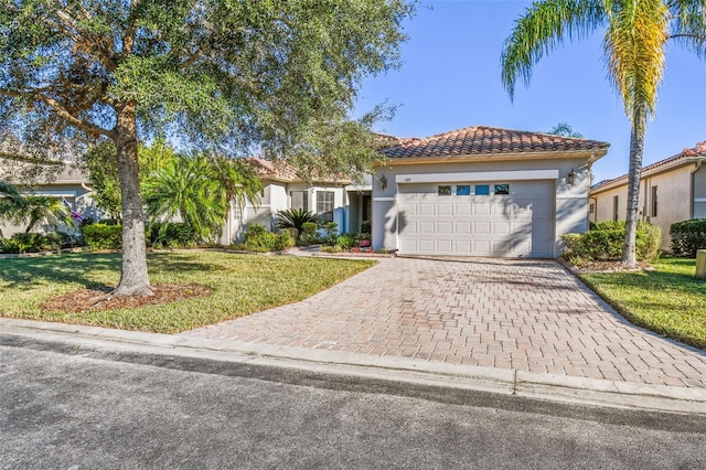 view of front of property featuring a front yard and a garage