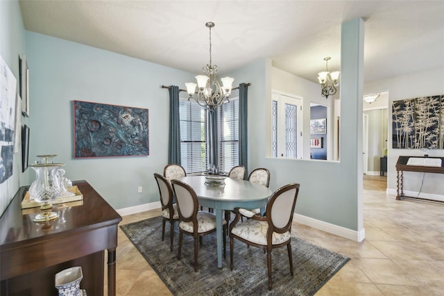 tiled dining space with a notable chandelier