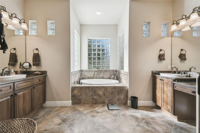 bathroom with vanity and tiled bath