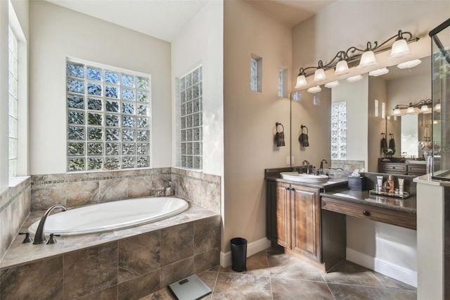 bathroom featuring vanity and tiled tub