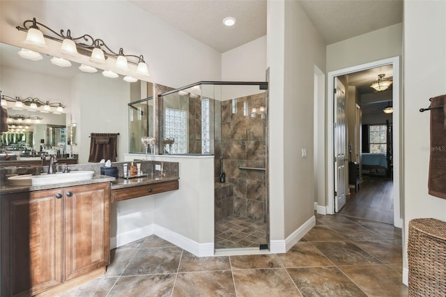 bathroom with vanity, a textured ceiling, and walk in shower