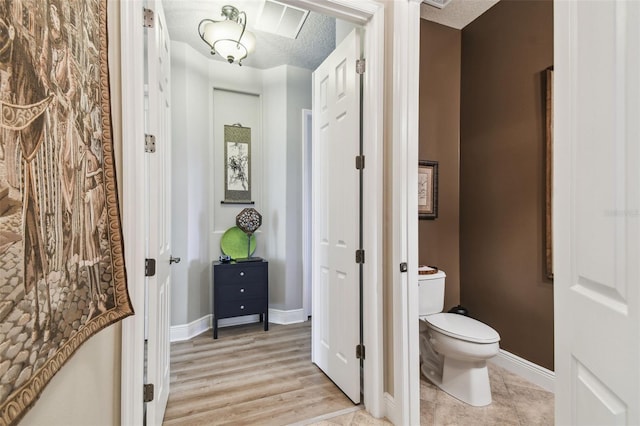 bathroom featuring toilet and a textured ceiling