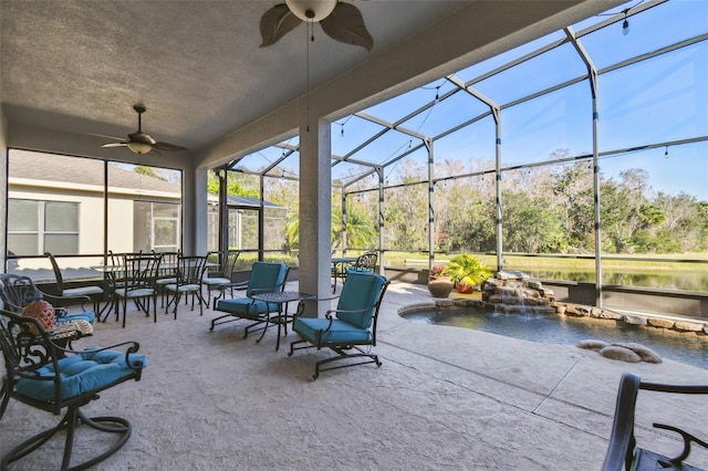 view of patio / terrace with pool water feature, glass enclosure, and ceiling fan