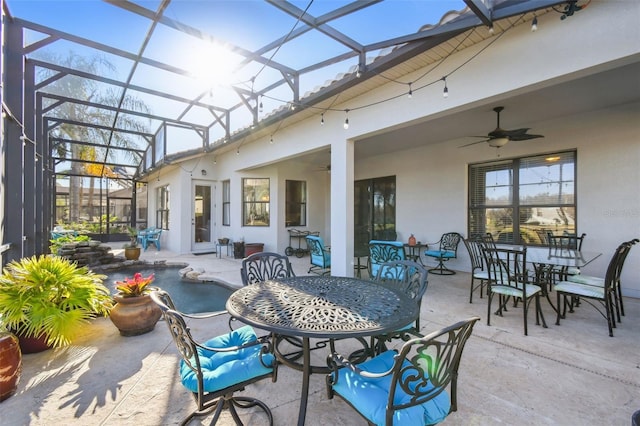 view of patio / terrace featuring ceiling fan and a lanai