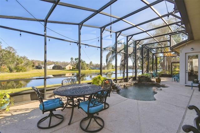 view of patio / terrace with glass enclosure, pool water feature, and a water view