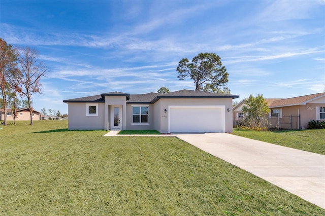 view of front of home featuring a front yard, driveway, an attached garage, and stucco siding