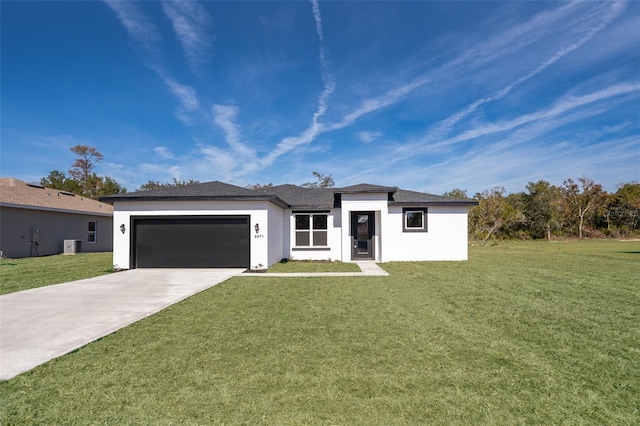 prairie-style house with an attached garage, driveway, a front lawn, and stucco siding